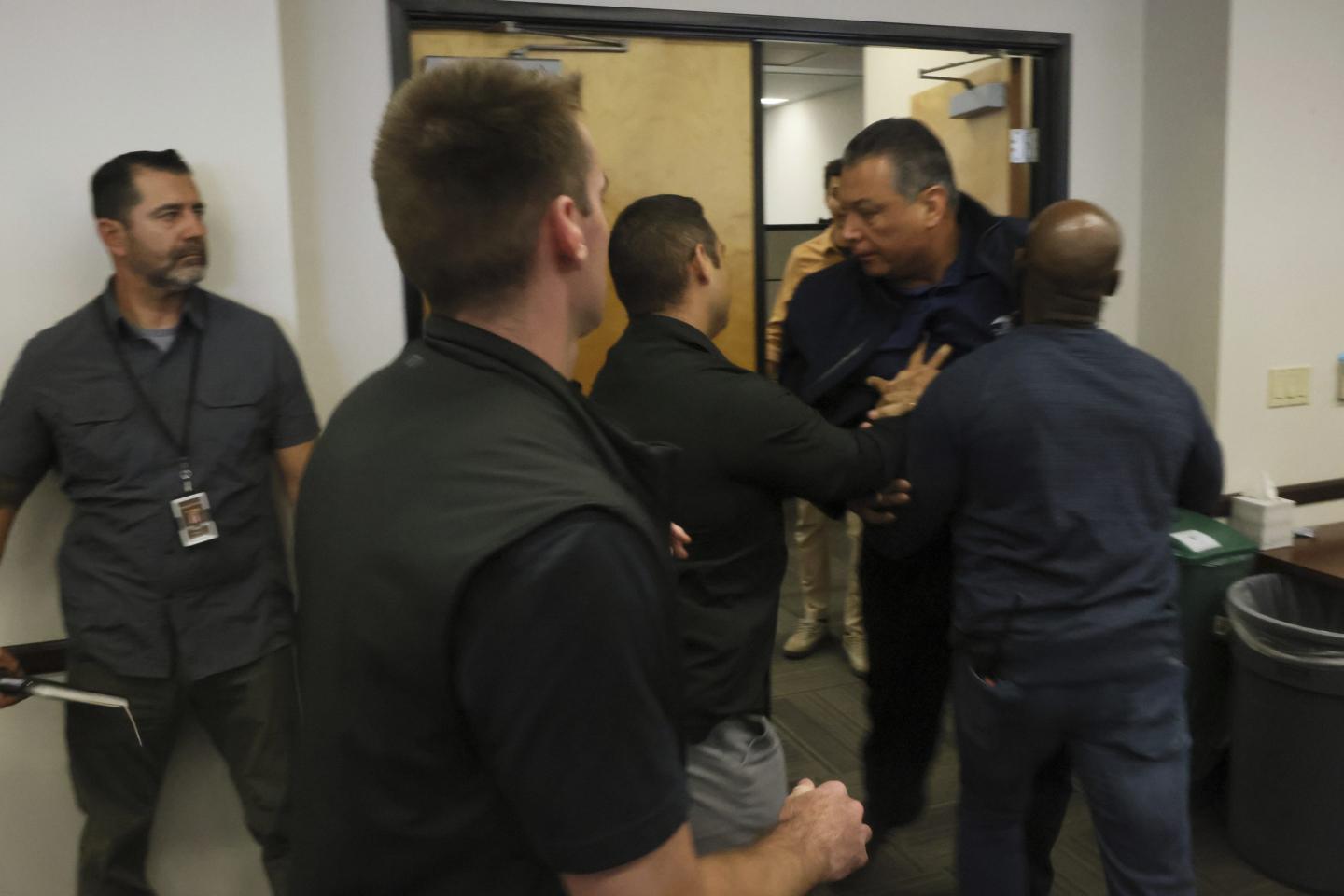 U.S. Sen. Alex Padilla, D-Calif., is pushed out of the room as Homeland Security Secretary Kristi Noem holds a news conference regarding the recent protests in Los Angeles on Thursday, June 12, 2025.