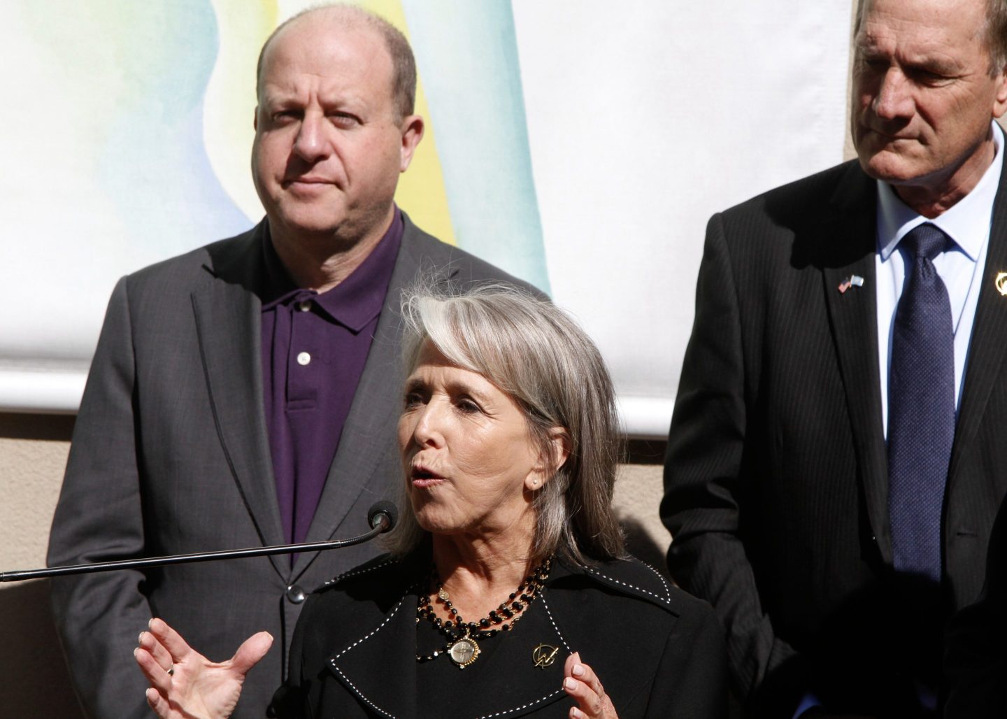 Governor Michelle Lujan Grisham of New Mexico, center, watched by Governors Larry Rodin of South Dakota, right, and Jared Polis of Colorado, talks about priorities for affordable housing and public lands in Santa Fe, N.M., on June 23, 2025.