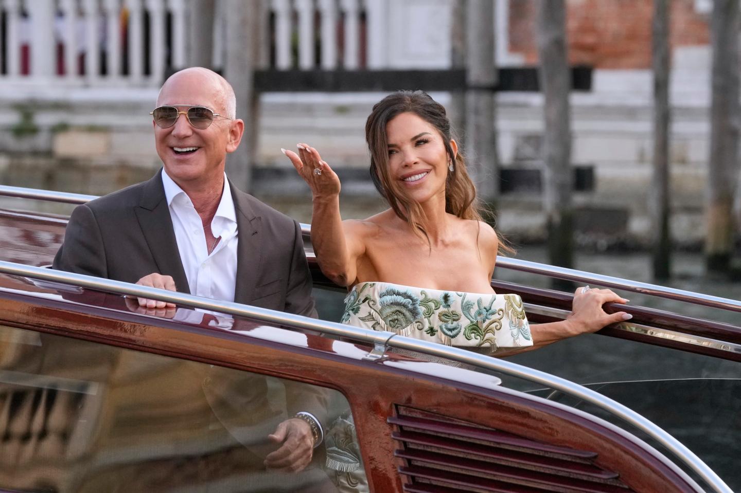 Jeff Bezos and Lauren Sanchez smile as they boat through the lagoon to their pre-wedding reception in Venice on June 26. The event was held at the Madonna dell'Orto on the first day of the three-day wedding celebration.