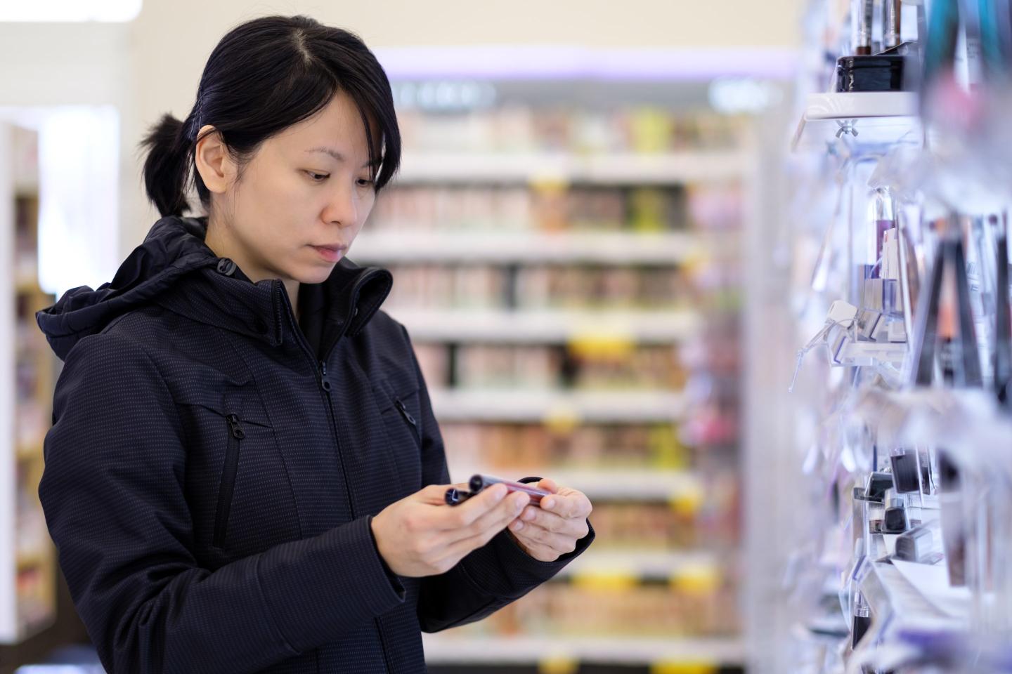 Asian woman looking at cosmetics