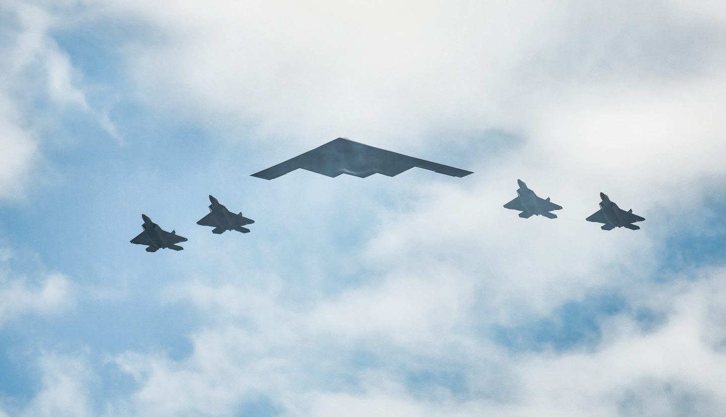 F-22 Raptors and a B-2 Stealth Bomber fly over the Hudson River on July 4, 2020.