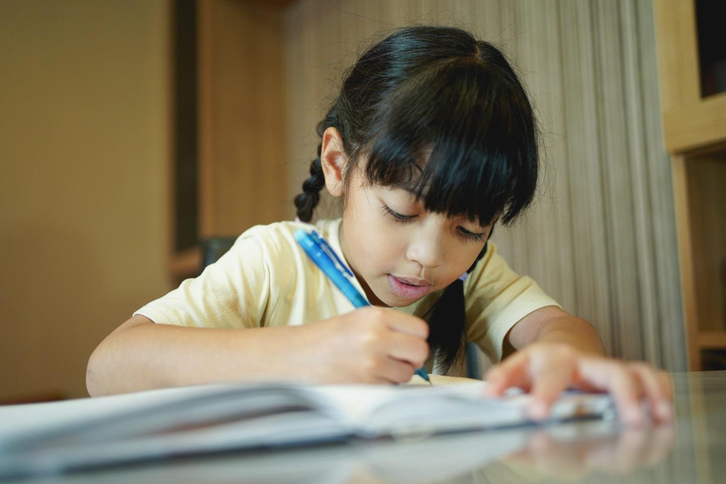 A girl writing in a notebook