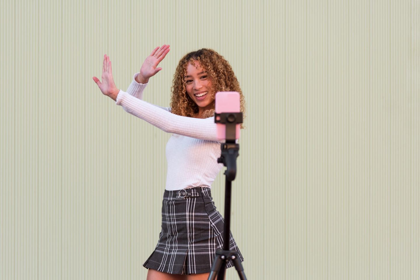 A girl films herself for a livestream