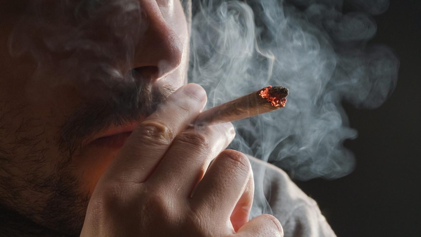 Closeup of man smoking marijuana joint