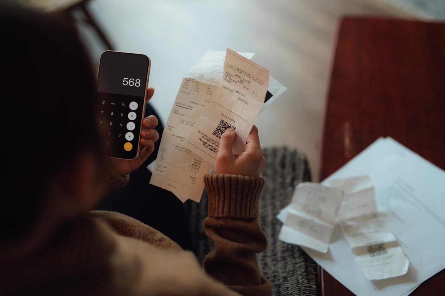Photo of a young woman doing financial calculations