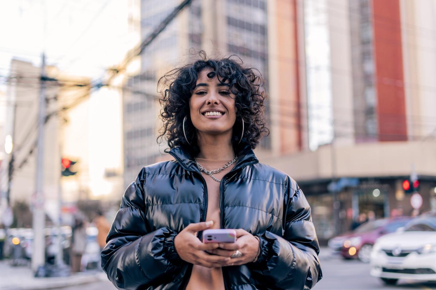 Gen z woman on phone in city.