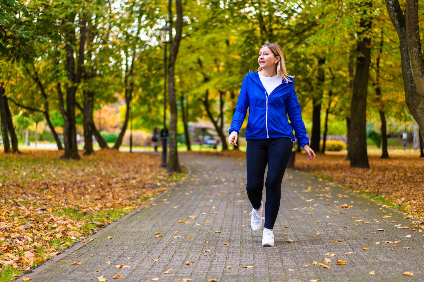 Photo of a woman walking in a park