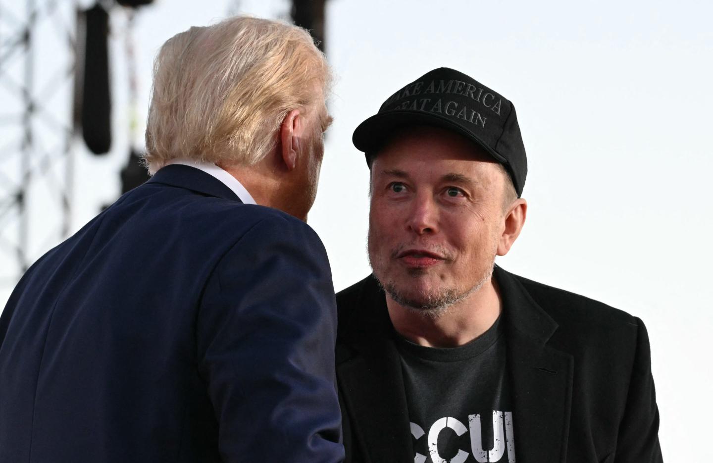 Trump and Musk lean into each other to talk
