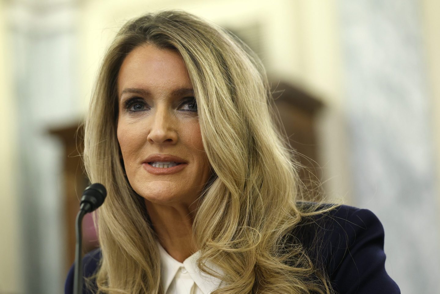 Kelly Loeffler speaks into a microphone