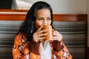 Photo of a woman sipping from a mug