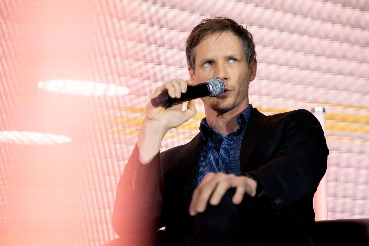 Hugging Face's Thom Wolf speaking into a microphone.
