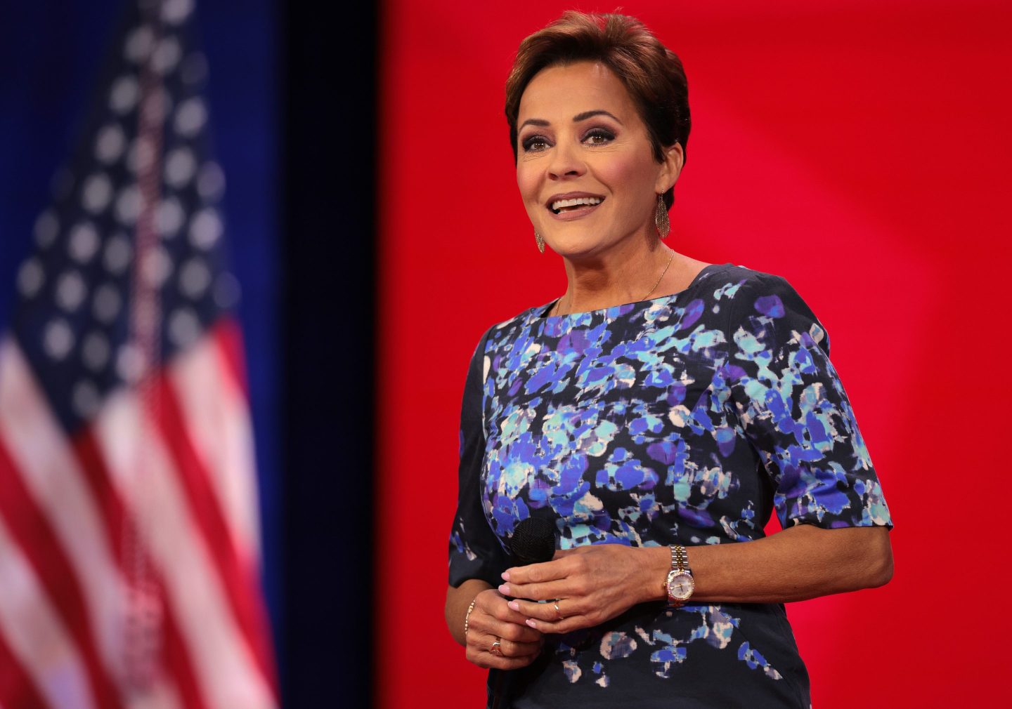 Kari Lake next to an American flag