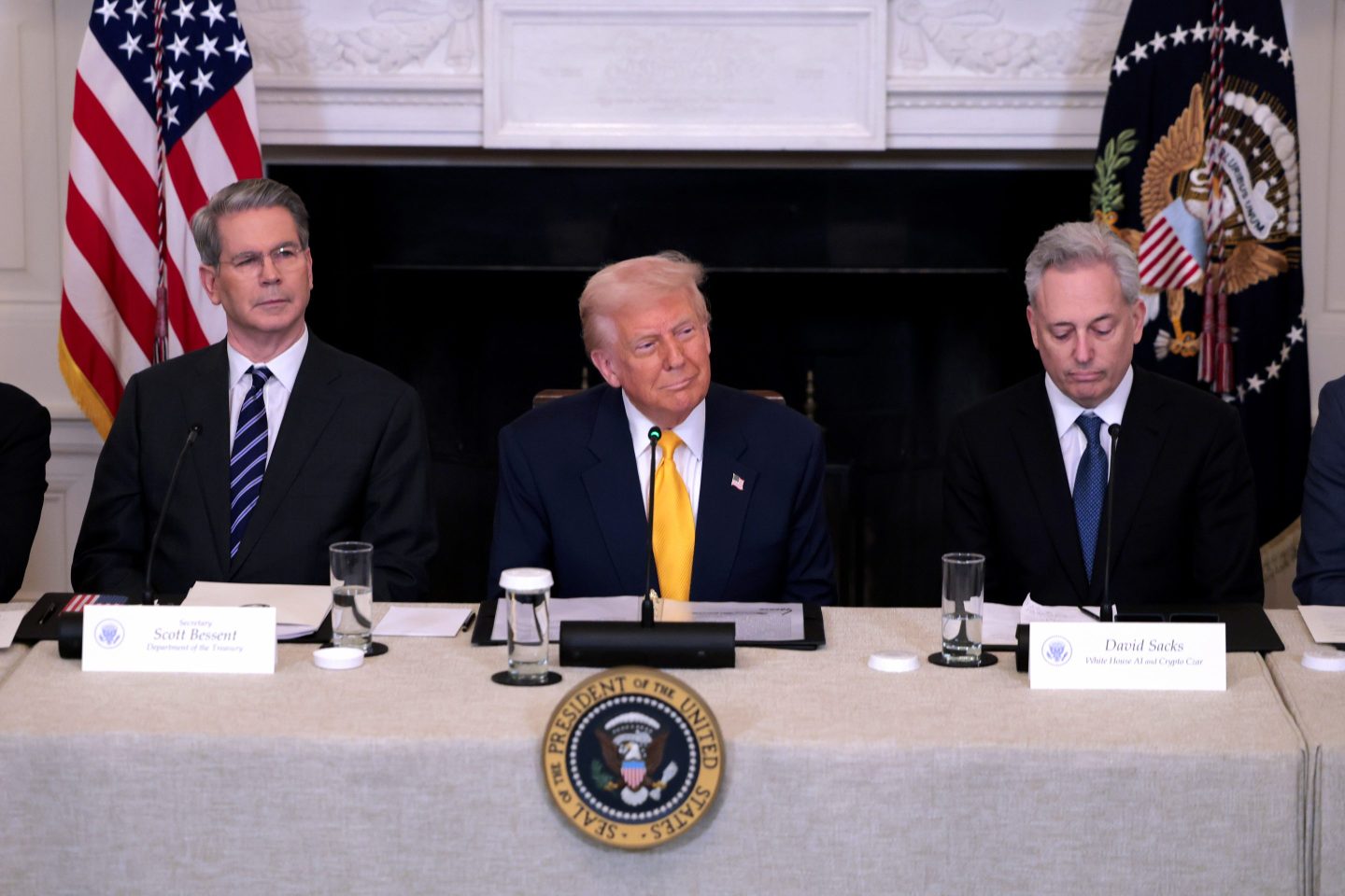 President Donald Trump speaks alongside Treasury Secretary Scott Bessent (left) and White House crypto czar David Sacks at the White House Digital Assets Summit on March 7, 2025.