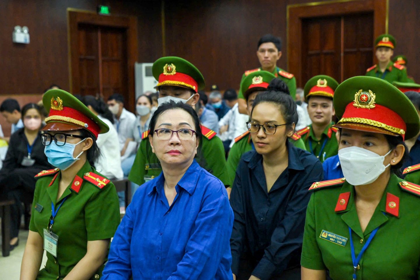 Vietnamese property tycoon Truong My Lan (C-L) looks on at a court in Ho Chi Minh city on March 25, 2025.