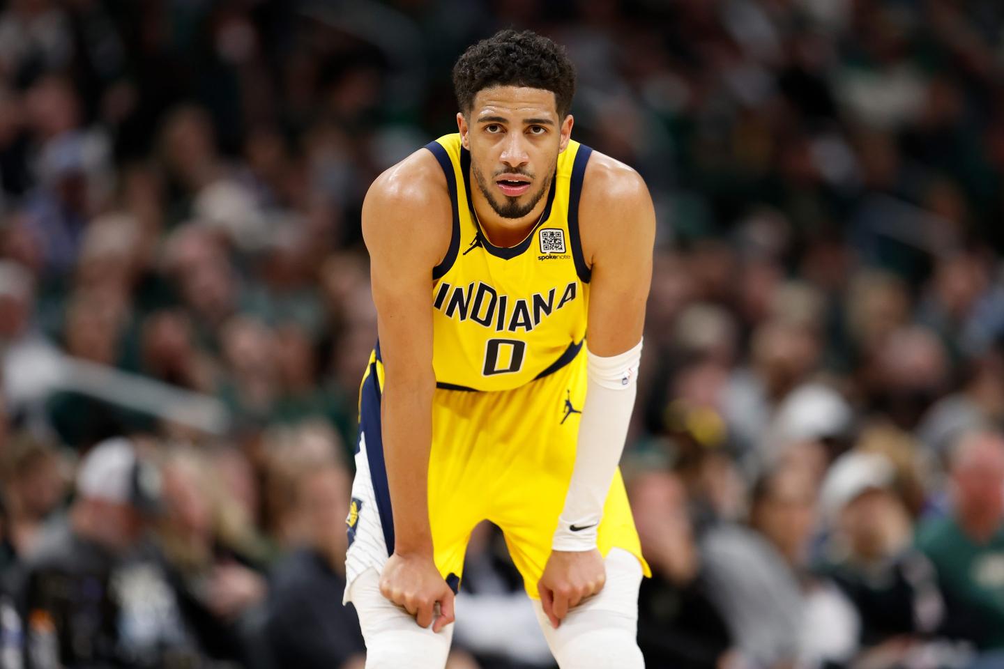 Tyrese Haliburton stands hunched over during a game