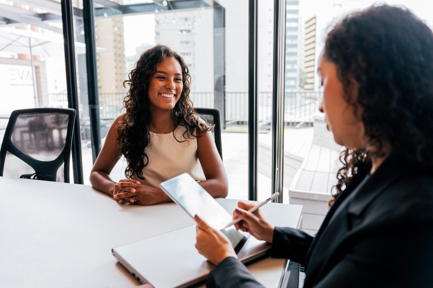 women at a job interview wearing business attire