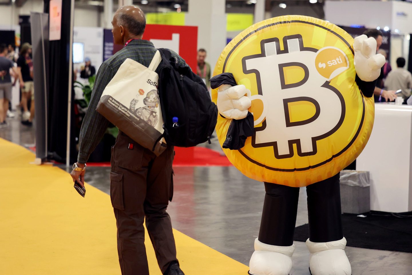 bitcoin mascot costume and bitcoin conference attendee