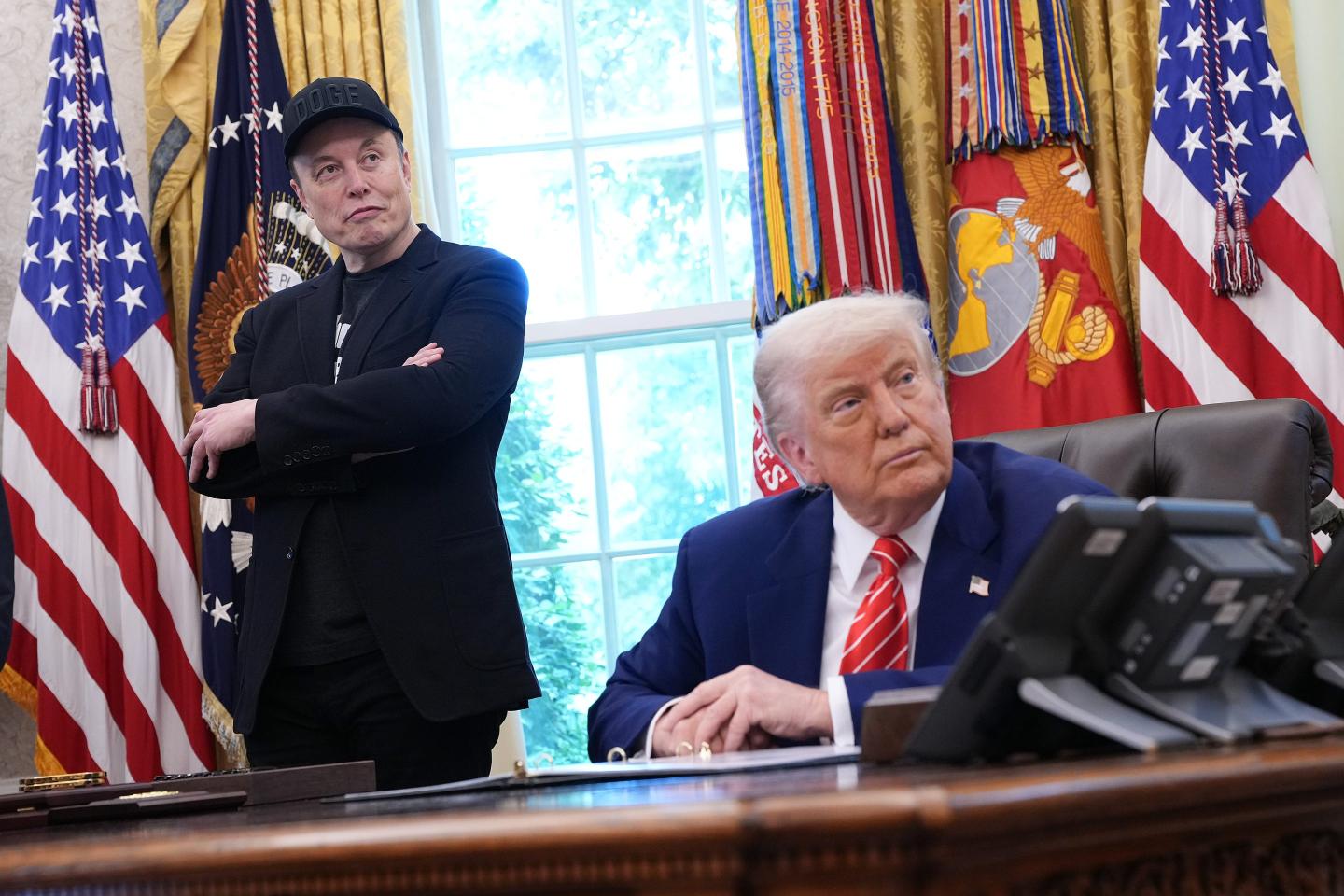 Tesla CEO Elon Musk and U.S. President Donald Trump listen to a question from reporters in the Oval Office of the White House on May 30, 2025 in Washington.