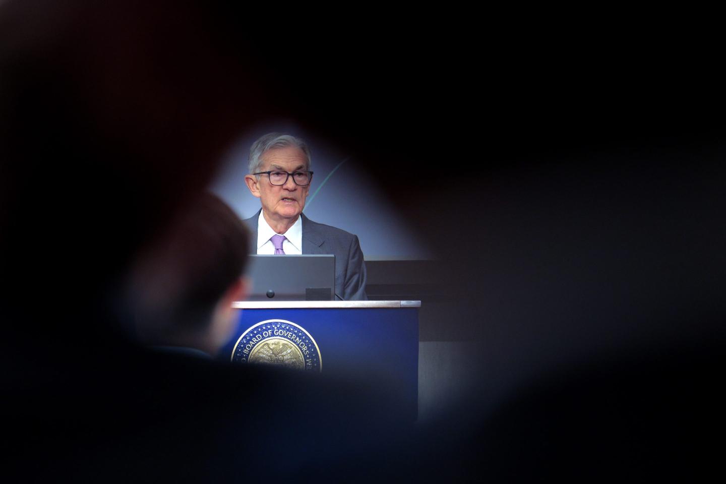 Jerome Powell surrounded by darkness
