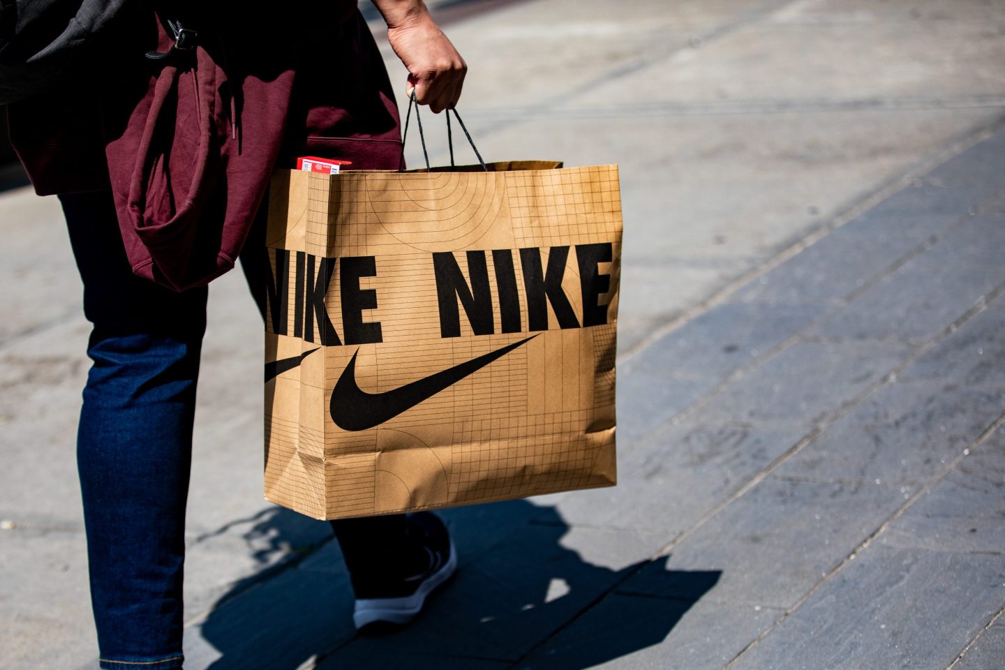 A shopper carries a Nike bag in downtown Detroit on June 7.