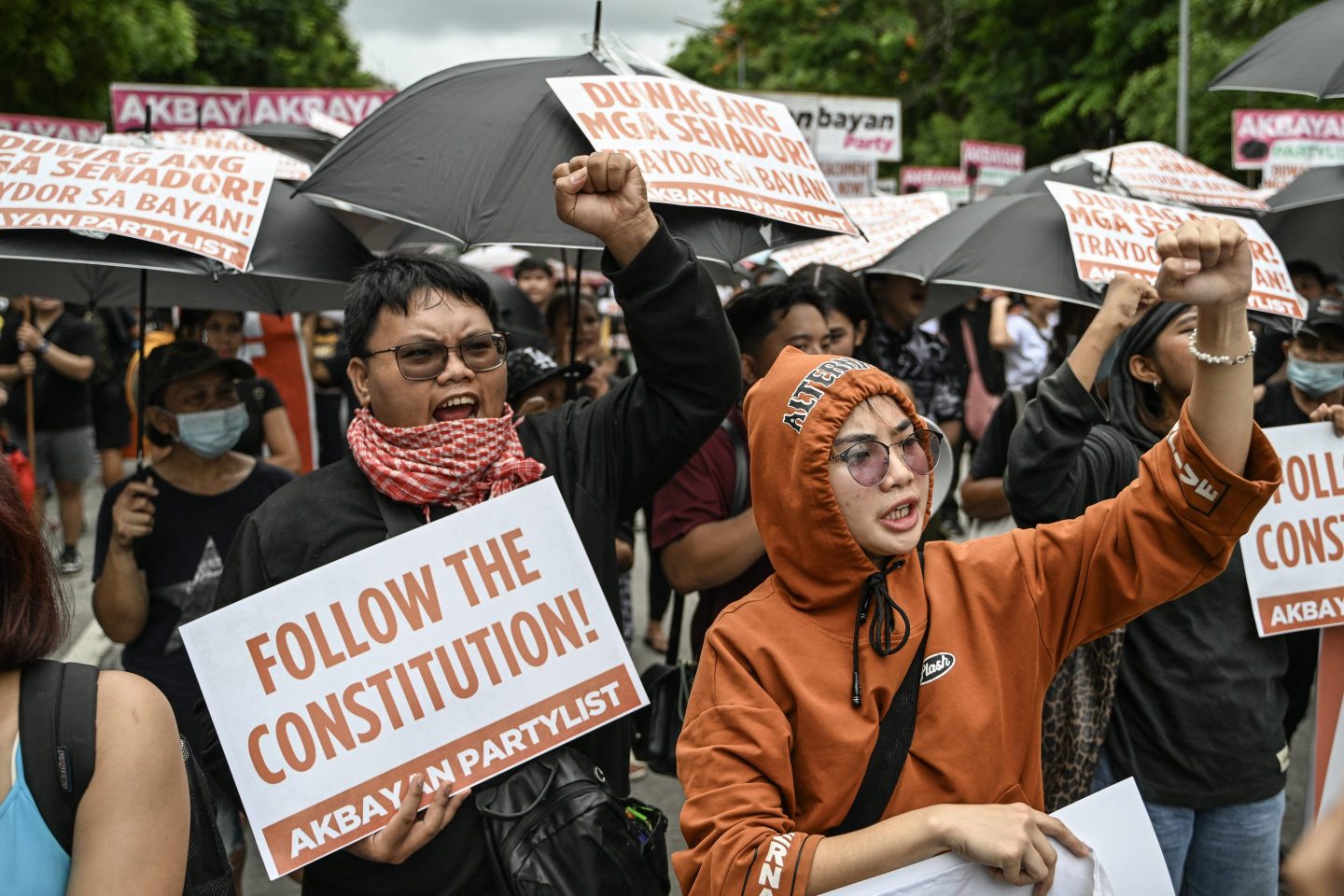 People hold placards and shout slogans as they protest following the Senate's decision on the impeachment trial of Philippine Vice President Sara Duterte, outside the Senate of the Philippines in Pasay, Metro Manila on June 11, 2025.