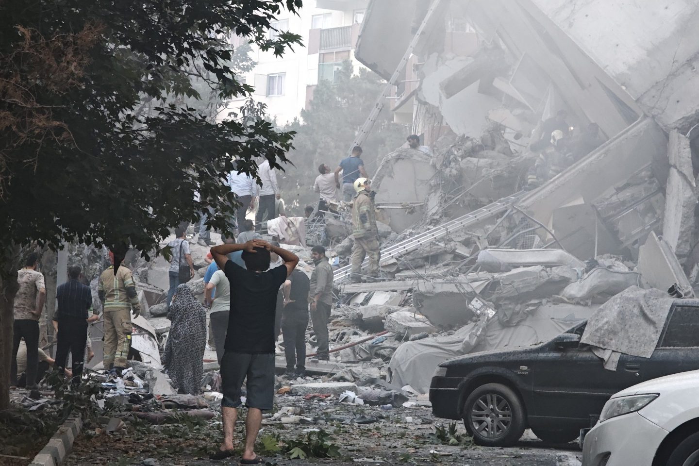 People look over damage to buildings in Nobonyad Square following Israeli airstrikes on June 13, 2025 in Tehran, Iran.