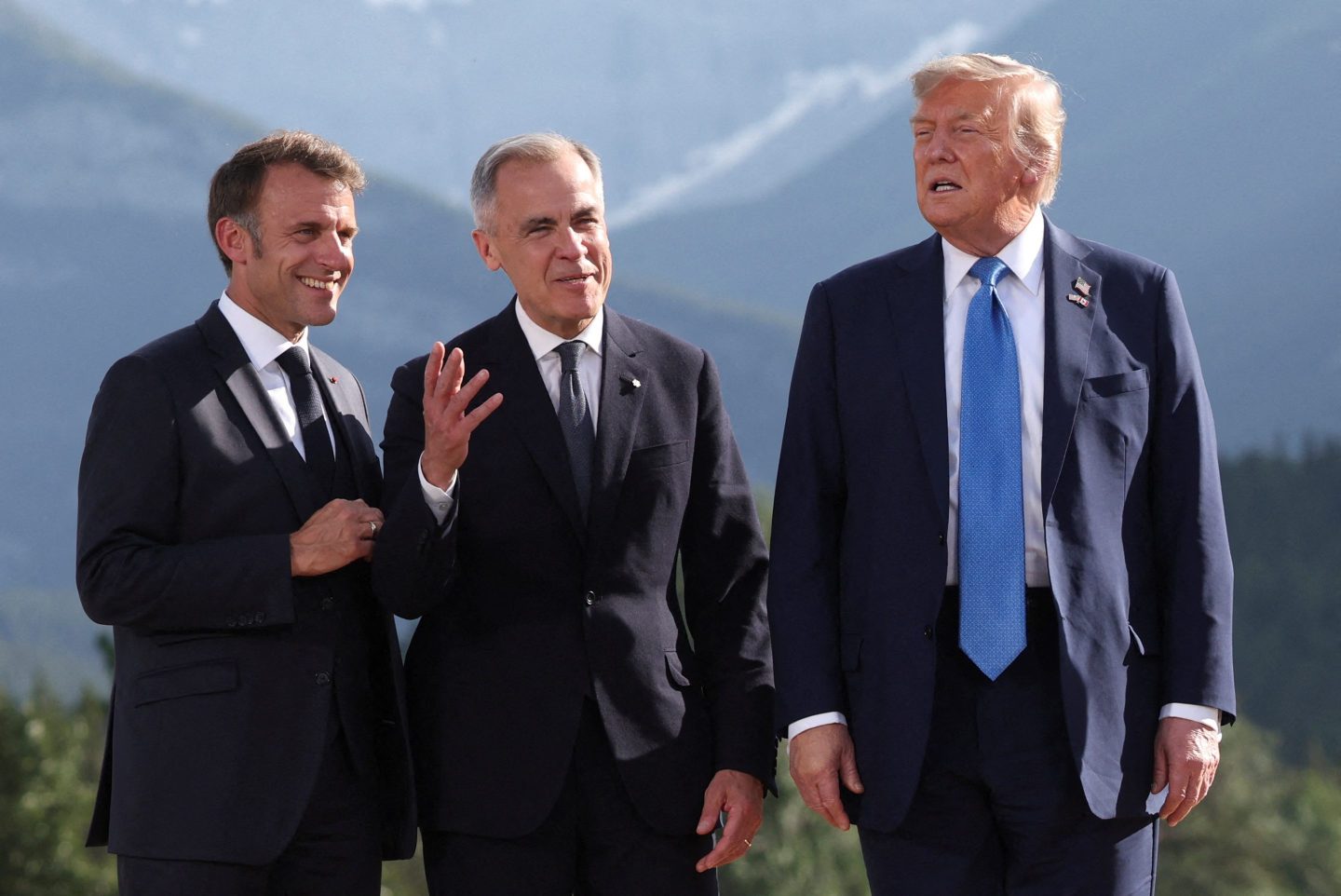 (L-R) French President Emmanuel Macron, Canadian Prime Minister Mark Carney and US President Donald Trump attend a family photo during the Group of Seven (G7) Summit at the Kananaskis Country Golf Course in Kananaskis, Alberta, Canada on June 16, 2025.