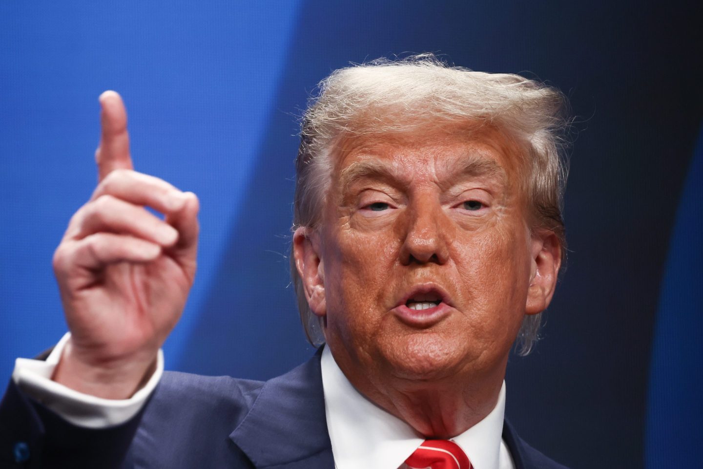 Donald Trump holds up an index finger