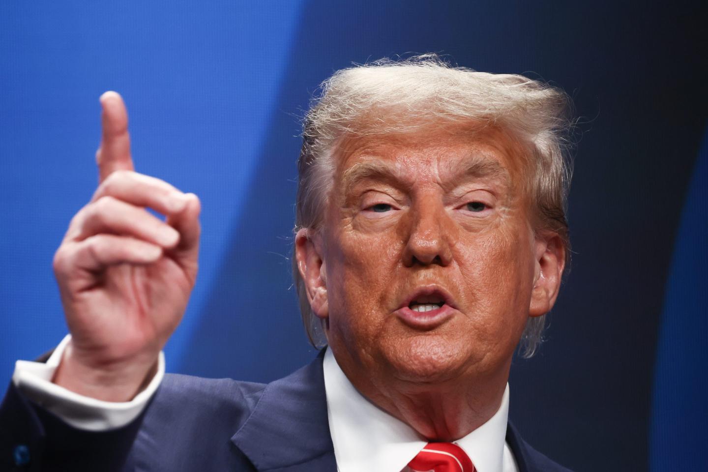 Donald Trump holds up an index finger