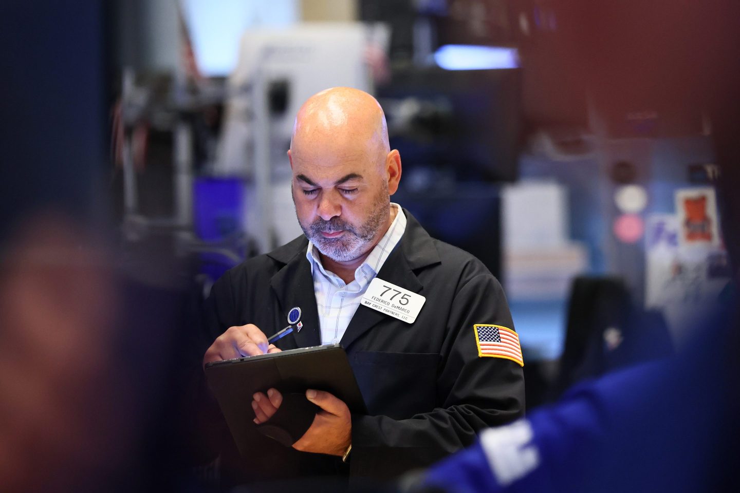 Traders work on the floor of the New York Stock Exchange during morning trading on June 23, 2025