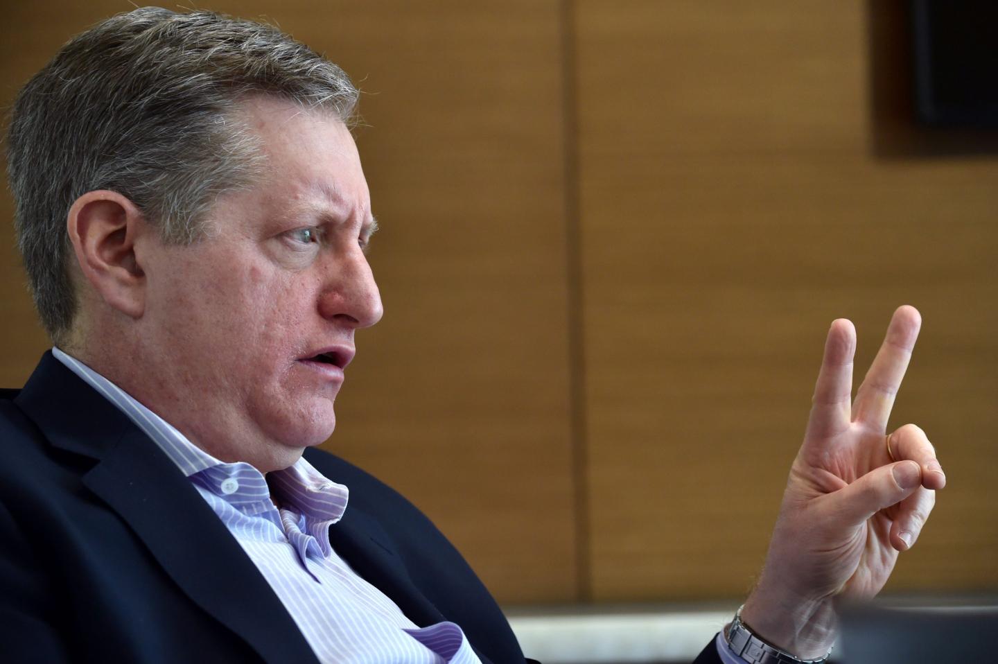 Steve Eisman looks to his left and holds up two fingers.