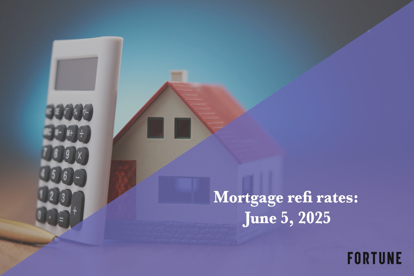 A calculator propped up against a tiny house.