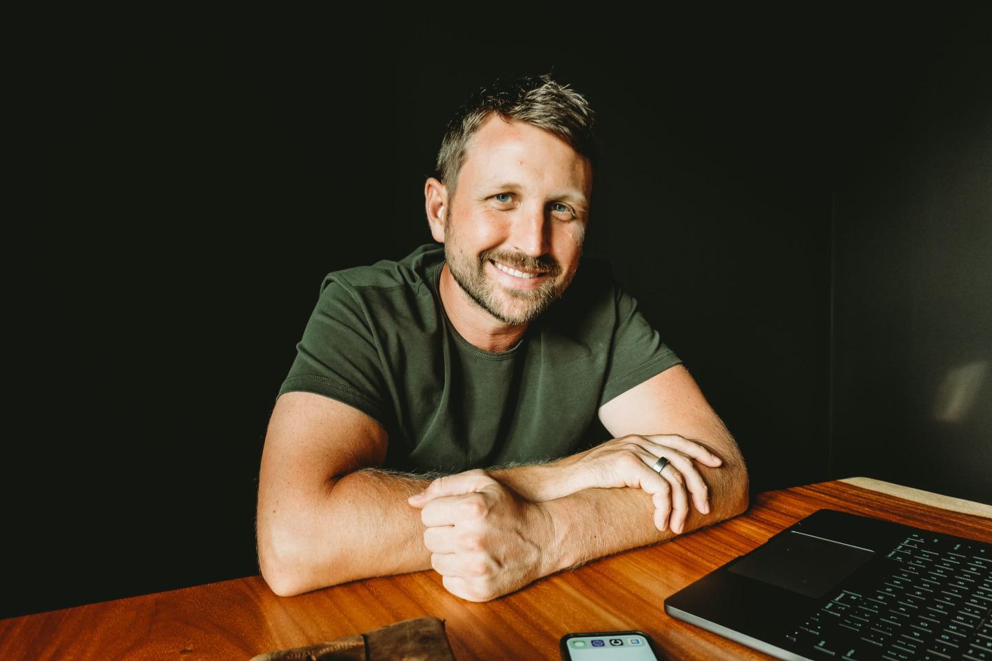 A headshot of Shane Mac smiling.