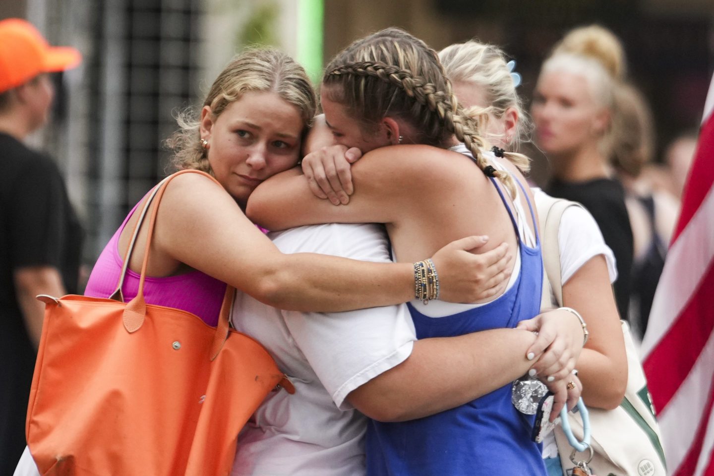 Campers embrace after arriving at a reunification area Saturday as girls from Camp Waldemar are reconnected with their families.