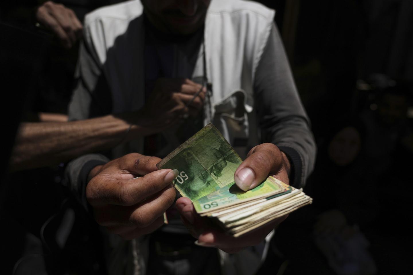 Inside Gaza’s world of ‘cash brokers’ as currency disappears: ‘We lose nearly half of our money just to be able to spend it’