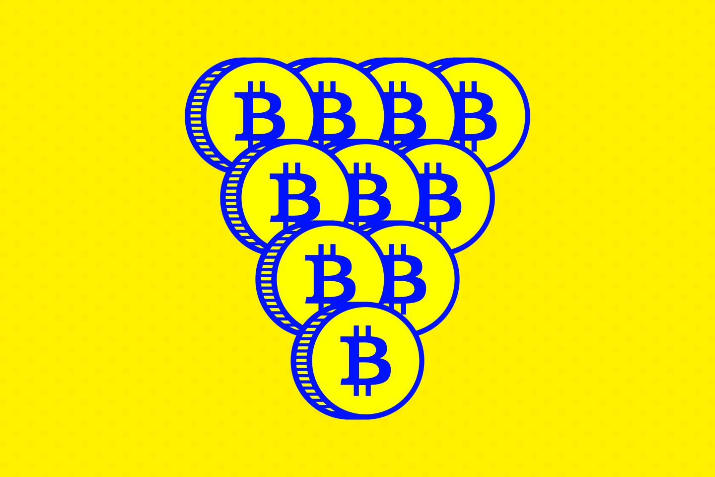 Coins with the Bitcoin logo imprinted on them stacked into a pyramid.