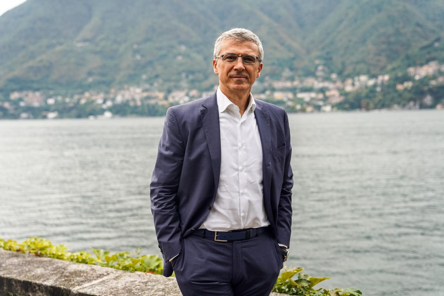 Diego Piacentini stands in front of a body of water