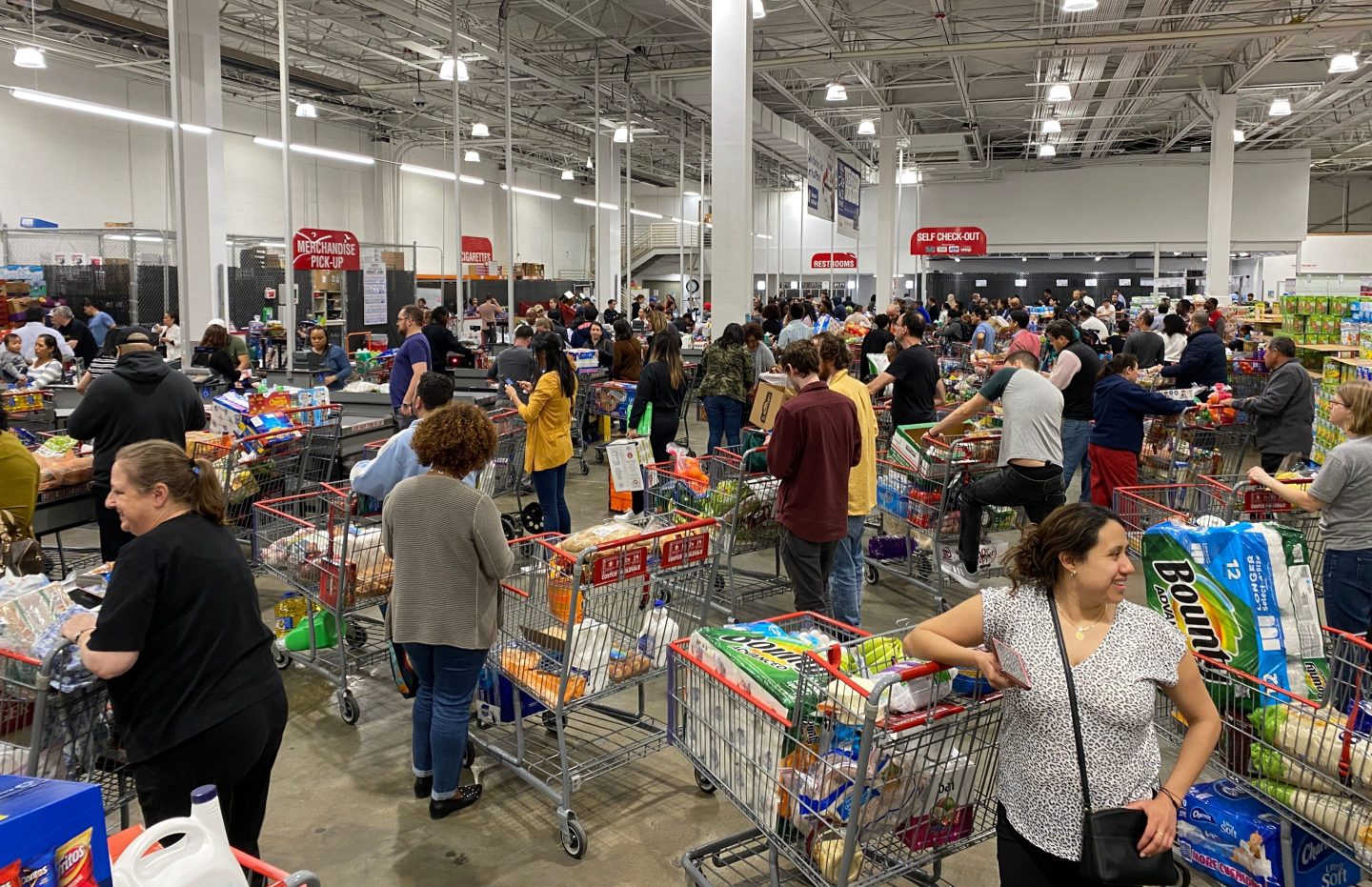 Long lines in a crowded grocery store