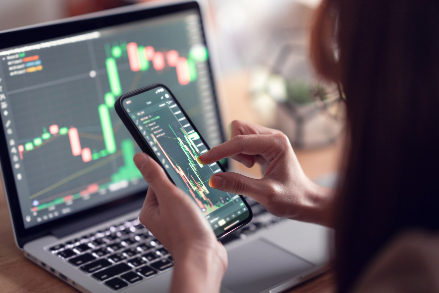 An executive is checking Bitcoin price chart on digital exchange on smartphone, cryptocurrency future price action prediction.
