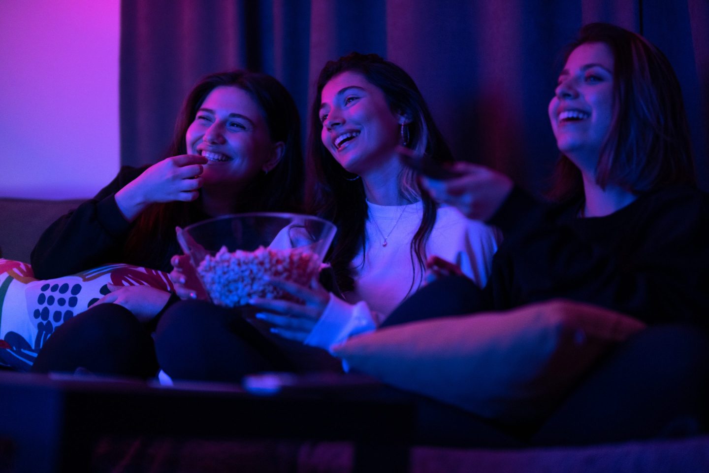 Teenagers watching TV on a couch