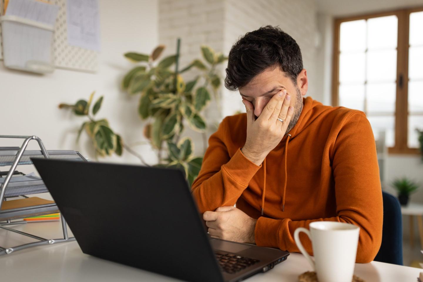 man stressed sitting at desk
