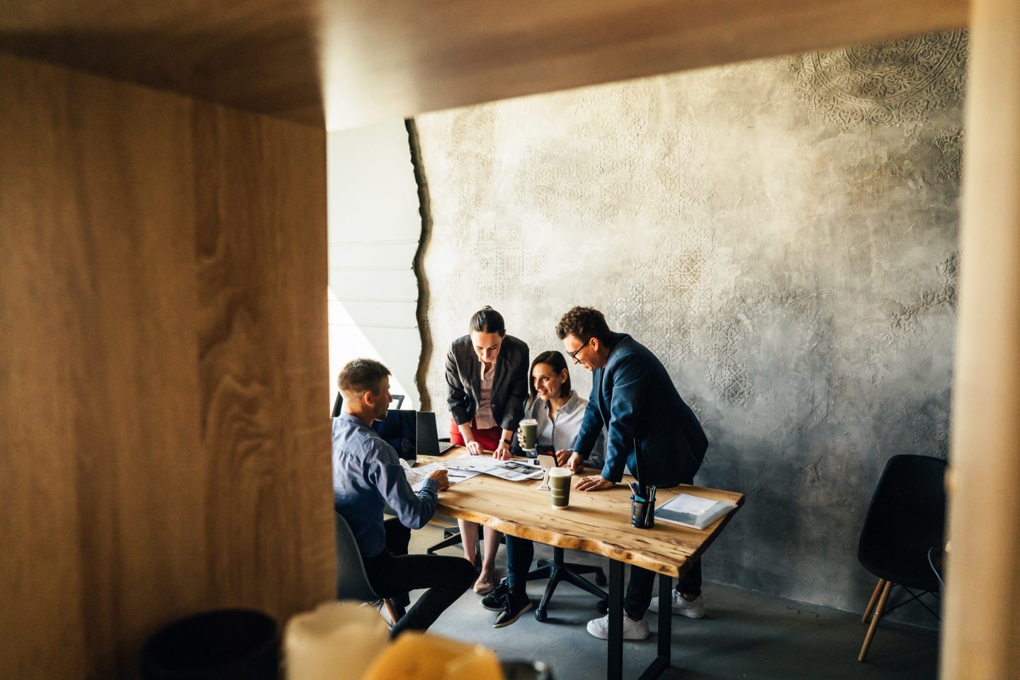Four colleagues sitting at the table in the office