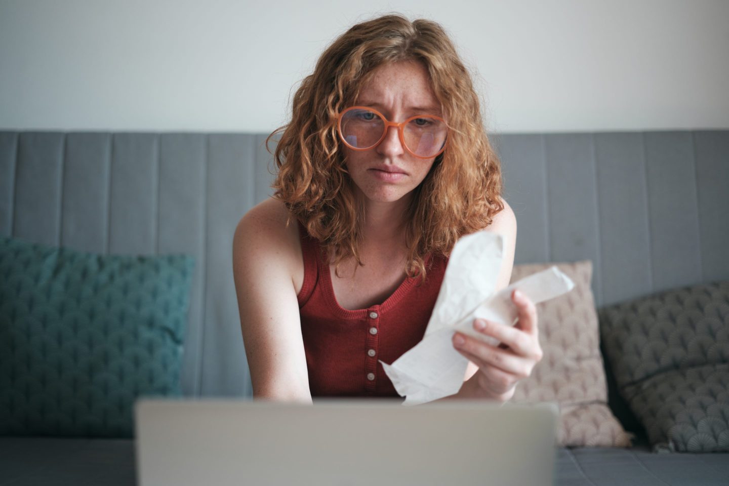 A worried student loan borrower checking their debt balance.