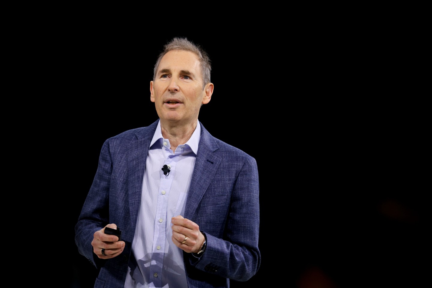 Andy Jassy looks off into the crowd from onstage at an Amazon event in 2025
