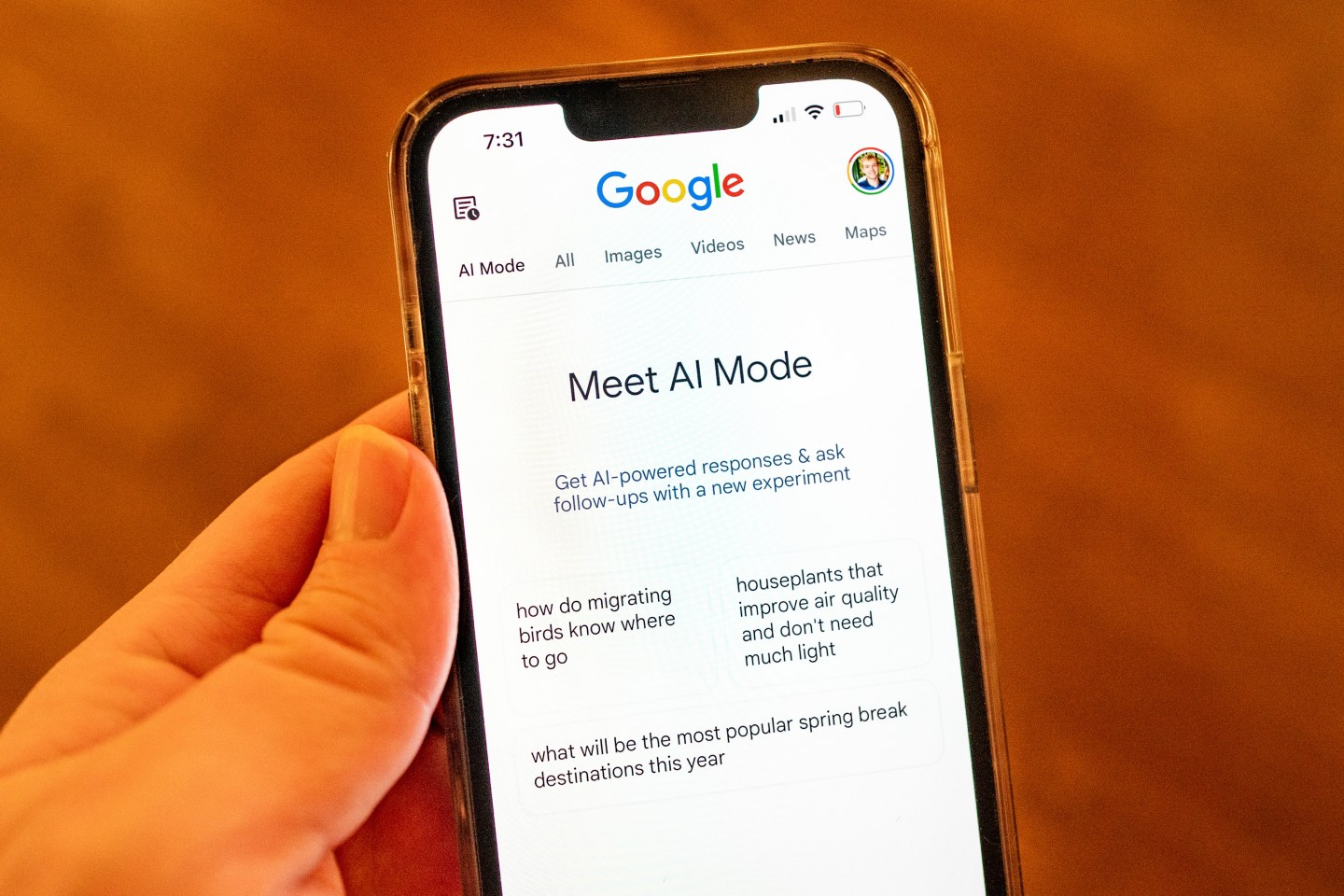 Someone holding a screen showing Google's AI Mode for Search.