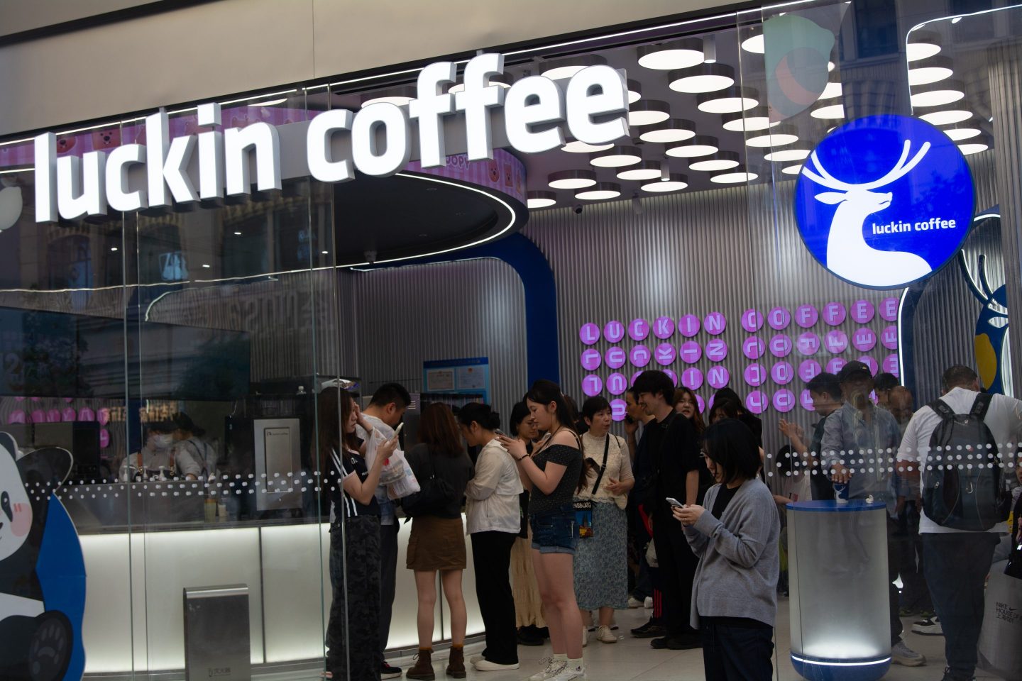 people standing in line at Luckin Coffee