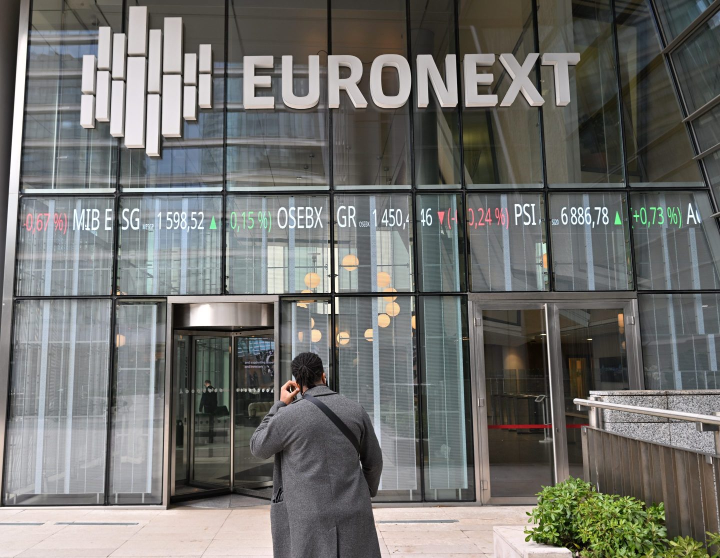 person in front of the Euronext Paris office