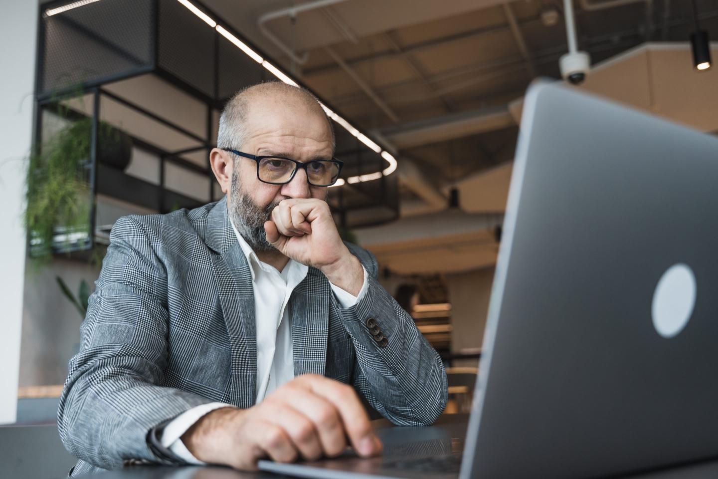 Older worker sad at laptop