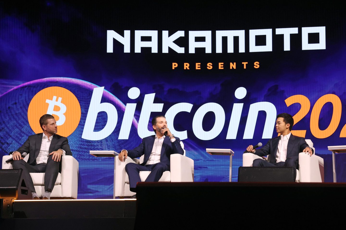 Eric Trump (left), Donald Trump Jr. (center), and Mike Ho, executive chairman and board member of American Bitcoin.