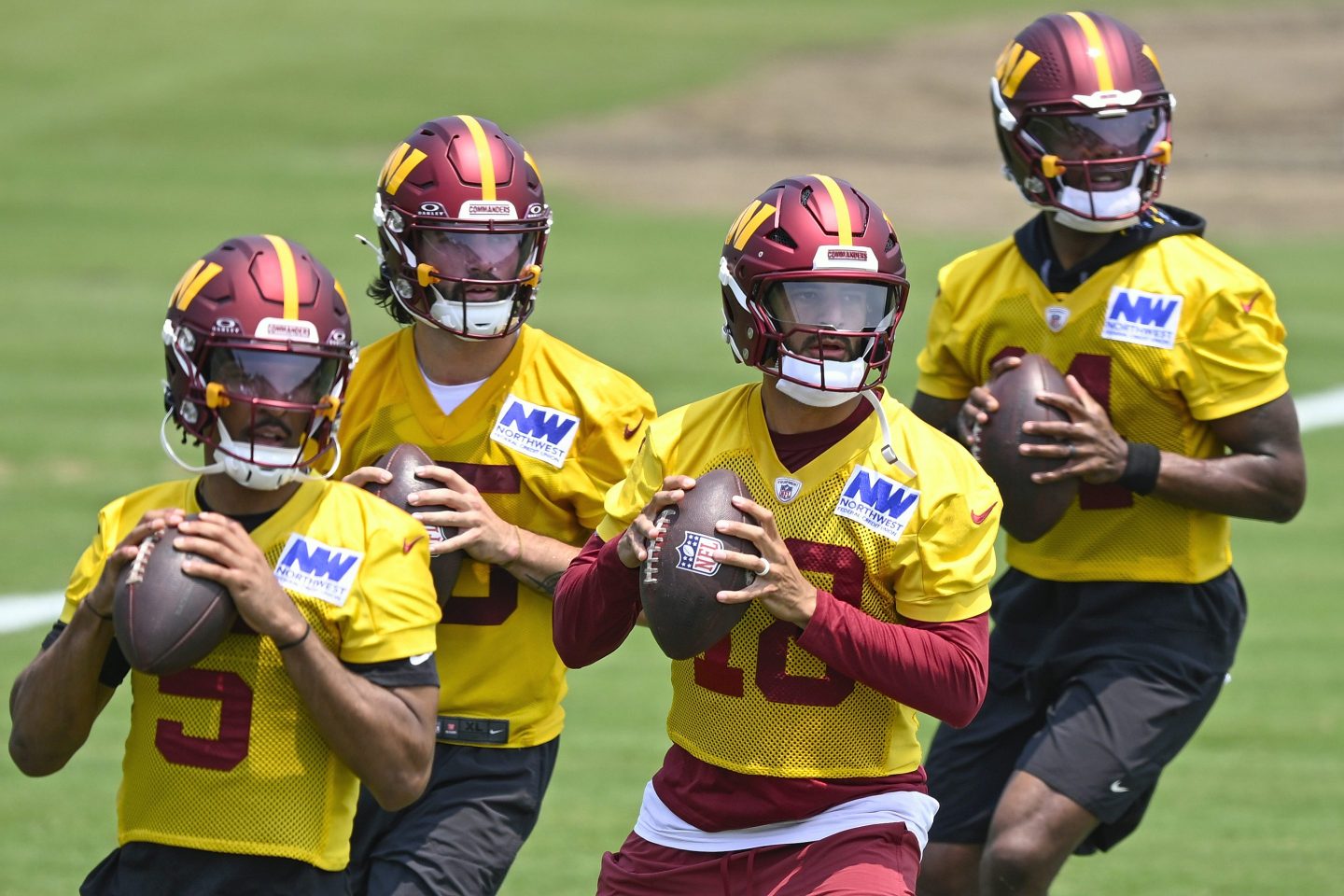 Washington Commanders quarterbacks Jayden Daniels, Sam Hartman, Marcus Mariota, Josh Johnson